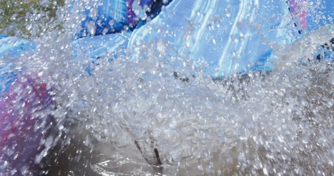 Kid Sliding down a Blow Up Water Slide