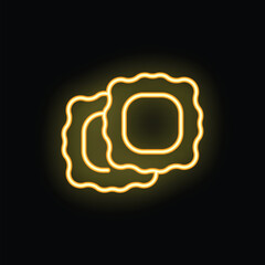 Neon sign showing two pieces of ravioli pasta glowing brightly on black background