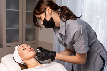 Before the procedure for facial contouring or plastic surgery, the cosmetologist makes markings on the patient face. Time to prepare for a cosmetic procedure.