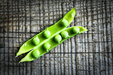 Fresh Green Peas in Pod on Rustic Wooden Surface