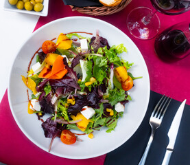 Healthy salad with arugula, vegetables and feta cheese