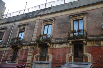 Characteristic Italian facades of tenement houses with balconies in Catania