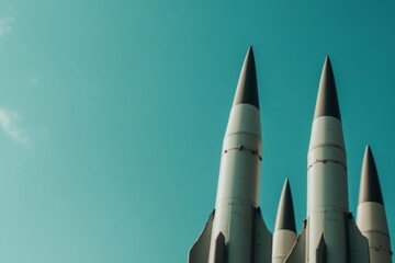 Cluster of military missiles against clear blue sky
