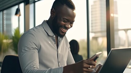 Fototapeta premium Happy Black male employee reading on a digital device, using a tablet or making a video call in a modern office