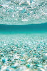 Close-up microplastics particles floating in clear water, concept of environmental impact, plastic pollution in drinking water sources. 