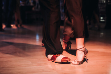 Dancing stiletto shoes of couples dancing traditional latin argentinian dance milonga in the...