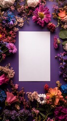 Obraz premium Blank paper framed by colorful dried flowers on purple background