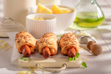 Homemade hot dogs with herbs, cheese and puff pastry.