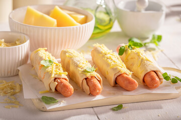 Unhealthy hot dogs served on a light table.