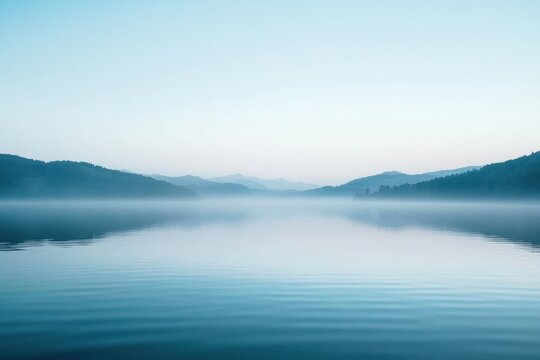 Serene morning on a calm lake surrounded by misty mountains with gentle ripples reflecting the soft light. Generative AI