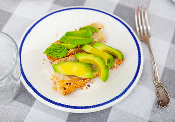 Delicious vegan sandwich with avocado and seeds closeup