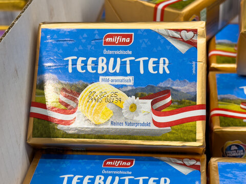 Milfina austrian teebutter packaging with natural scenery and red ribbon design