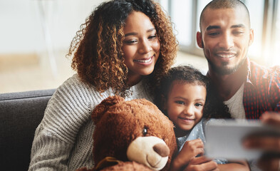 Happy family, hug and selfie with teddy bear on sofa for photography, picture or memory together at...
