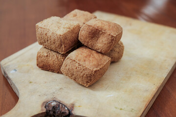 Tahu sumedang on wooden cutting board, is a typical sumedang tofu, west java which is brown and thick in it, served warm with chili.