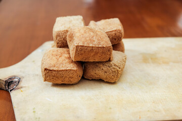 Tahu sumedang on wooden cutting board, is a typical sumedang tofu, west java which is brown and thick in it, served warm with chili.