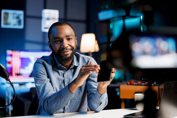 Content creator using high quality recording devices to shoot smartphone review for vlog channel on online platforms. Internet star warmly welcoming dedicated viewers, filming mobile phone