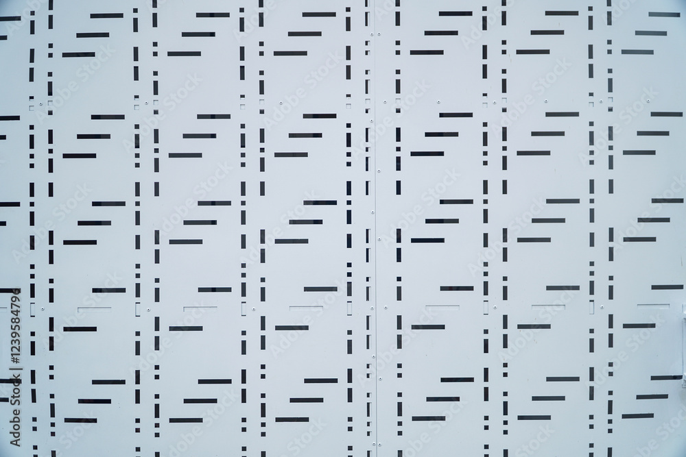 Poster close-up view of a repeating geometric pattern on a white metal gate surface. the design features sh