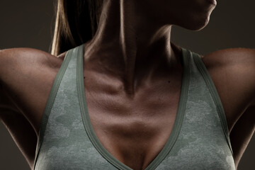 Close-up of a Woman Wearing a Green Sports Bra Highlighting Her Collarbone and Shoulders