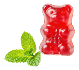 Red gummy bear next to fresh mint leaves on transparent background