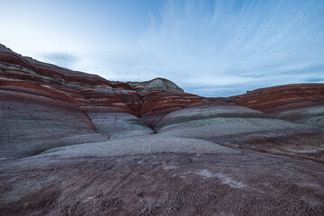 The colors of the otherworldly Bentonite Hills of Utah change and become more dramatic as the sun...