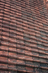 Close-up view of old terracotta roof tiles showing texture and pattern. Aged Terracotta Roof Tiles: A Textured Architectural Detail