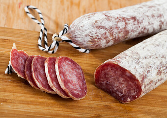 Spanish jerked pork sausage Longaniza on cutting board