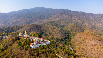 Wat Phra That Doi Kham temple overlooking forested mountains in Chiang Mai, Thailand