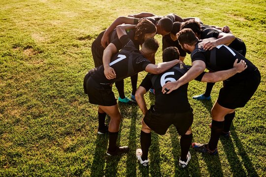 Rugby, team and huddle together for exercise, motivation and game field for match preparation. Above sports, fitness and group of men outdoor with competition planning, club and practice with talk
