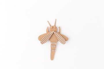 Fun craft project for kids featuring creative cardboard insect made from corrugated cardboard. DIY activity using recycled materials to promote creativity, fine motor skills, sustainability education