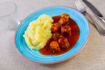 Delicious serving of meatballs served with mashed potatoes and gravy