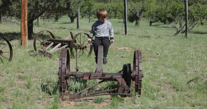 Boy Playing on Old Vintage Farm Equipment