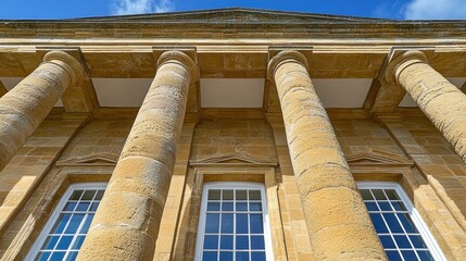 Low angle view of classical building facade with columns and windows.