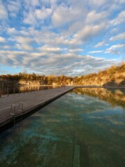 Naklejka premium ZAKRZOWEK SWIMMING POOL, a turquoise-filled quarry near Krakow known as the Polish Maldives, popular for recreation and diving neak Krakow town