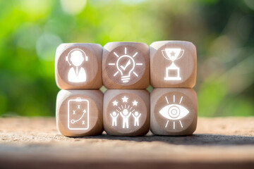 Wooden blocks with success icons representing achievement, innovation, and teamwork in a natural...