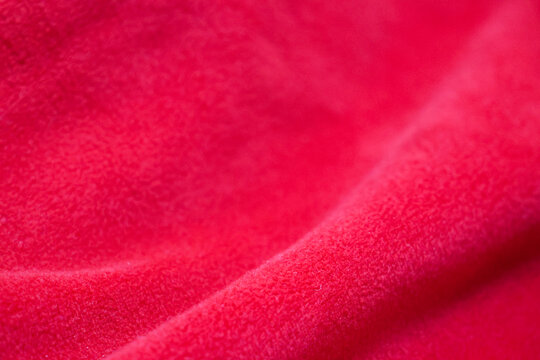 Red texture close up with gradient shadows, red textured cloth with shadows
