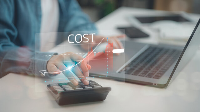 The businessman is pointing down the arrow of the graph with cost reduction business finance on the virtual screen. Business, technology, cost management, cut budget, cost reduction concept.