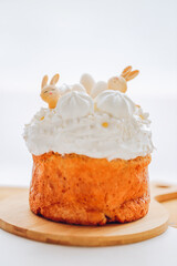 Easter Bunny Cake with Whipped Cream.Airy pastries with Easter decor in light colors on a wooden table. Spring festive desserts. Catholic and Orthodox holidays table.Cute Bunny Decoration on Cake 