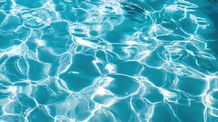 The captivating texture of pool water on a sunny day unfolds in a high-angle view, with ripples and reflections forming a serene, artistic pattern.