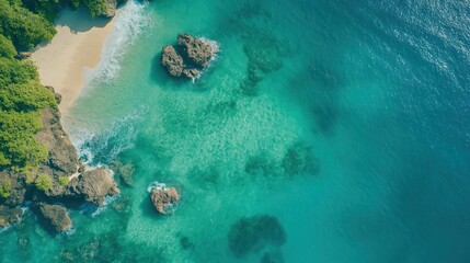 Aerial View of Secluded Tropical Beach with Turquoise Water, Rocky Shoreline and Lush Greenery