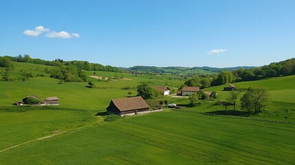 Obraz premium Idyllic Countryside View of Lush Green Fields and Traditional Farmhouses under Blue Sky