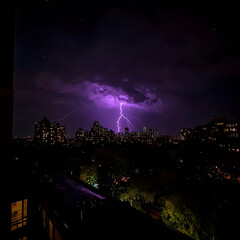 Fototapeta premium Lightning strikes illuminate the cityscape during a dramatic nighttime thunderstorm.