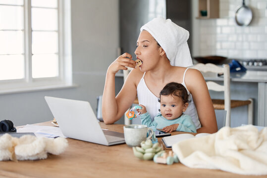 Eating, baby or mom multitasking with laptop for remote work, author or freelance life balance in home. Food, morning or mother juggling parenting task for responsibility, breakfast meal or deadline - Powered by Adobe