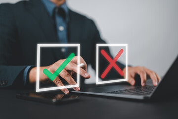 Businessman thinking and making choices between right and wrong symbols. Decide to vote concept. True, False, crisis decision-making. Yes or No decisions, business options in difficult situations.