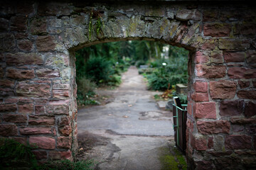 Stone Archway leads to a Serene Garden Path, promising Tranquility and Hidden Beauty.