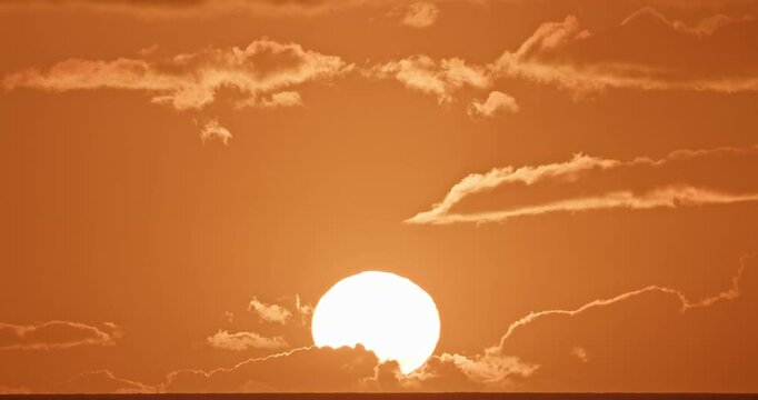 4K Sunset Timelapse Clouds Sky Sun Evening. Stunning time lapse of glowing afterglow with delicate clouds and vibrant orange atmosphere perfect for backgrounds nature scenes and cinematic projects