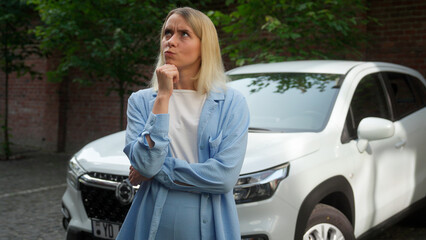 Pensive contemplative Caucasian woman buyer thinking in city pondering driver girl businesswoman...