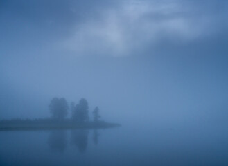 Fototapeta premium Fog Obscures Small Strip Of Land Along Yellowstone River