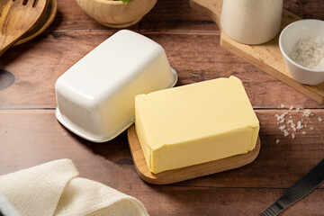 Butter block, grass-feed butter over wooden background. Vitamin D and source of fat 
