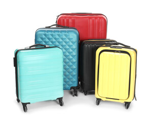Many closed colorful suitcases isolated on white