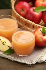 Tasty apple juice and fresh fruits on wooden table, closeup